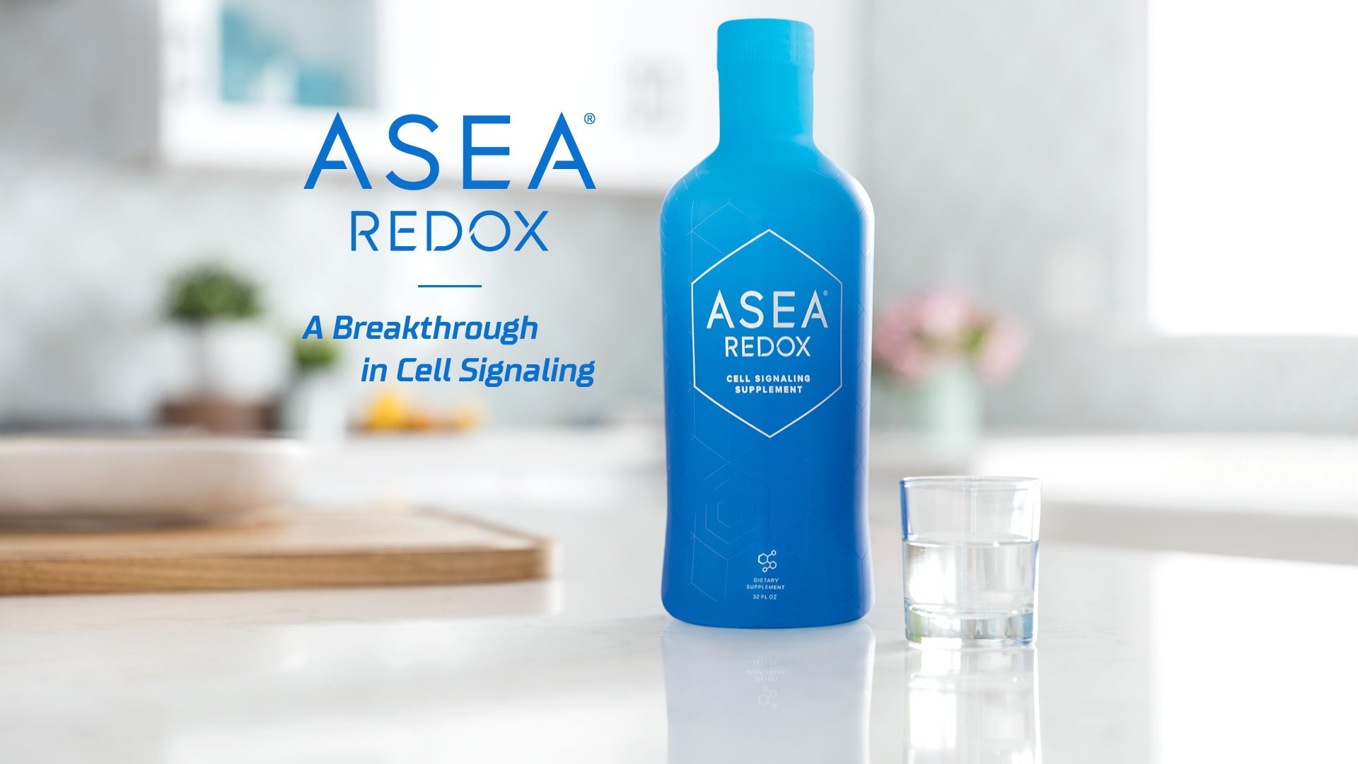 Blue bottle with Asea Redox logo and cup of water on a table